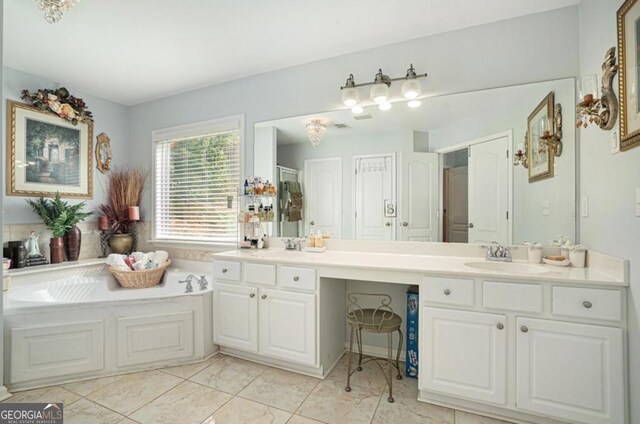 bathroom featuring tile patterned floors, a tub, and vanity