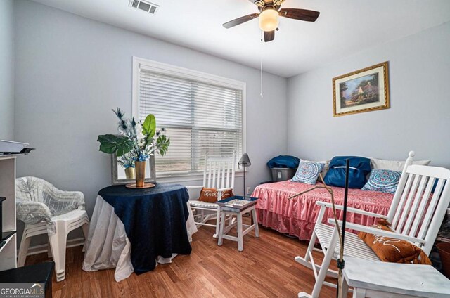 bedroom featuring hardwood / wood-style flooring and ceiling fan