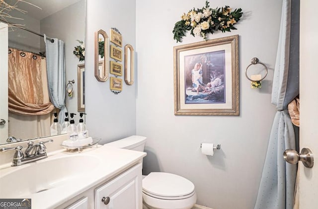 bathroom featuring vanity and toilet