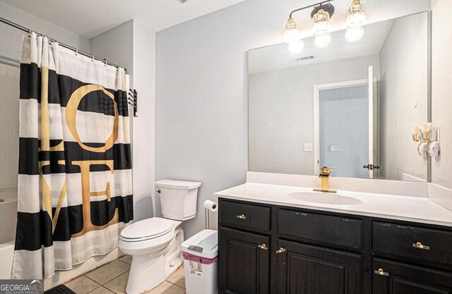 full bathroom featuring tile patterned floors, vanity, toilet, and shower / bathtub combination with curtain