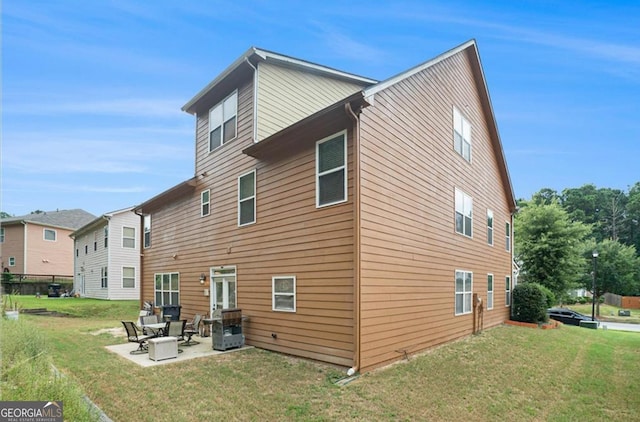 rear view of property with a patio area and a lawn