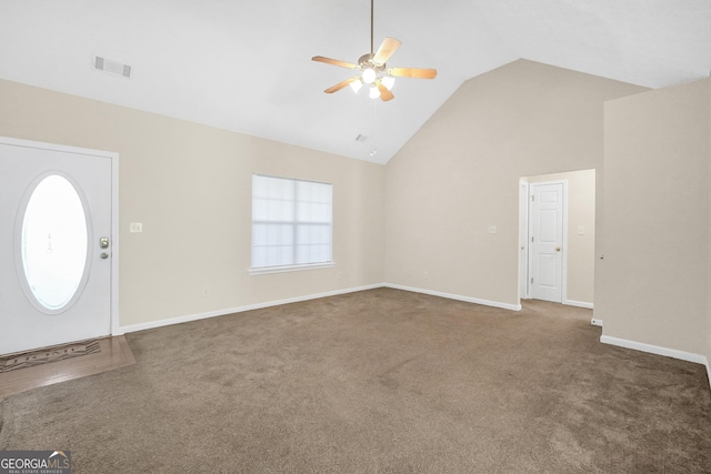 entryway with a wealth of natural light, high vaulted ceiling, and dark carpet