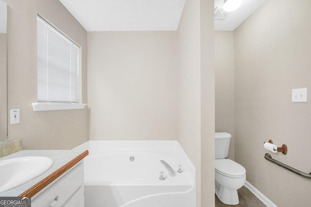 bathroom with vanity, a bathing tub, tile patterned floors, toilet, and a textured ceiling