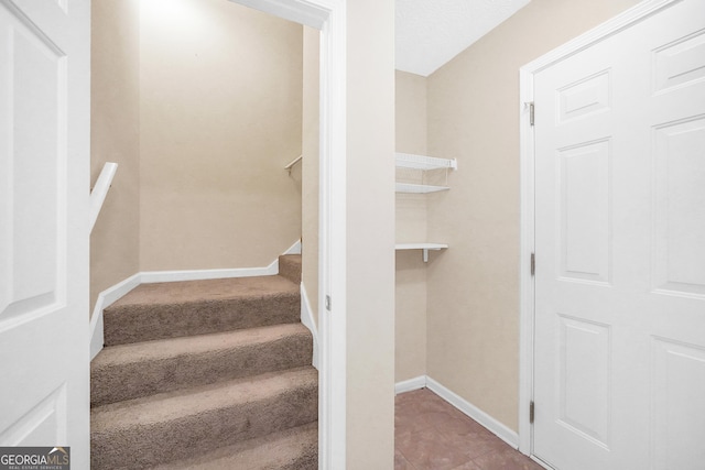 stairs featuring tile patterned flooring