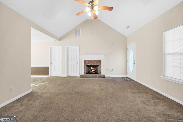 unfurnished living room with a brick fireplace, carpet floors, high vaulted ceiling, and ceiling fan