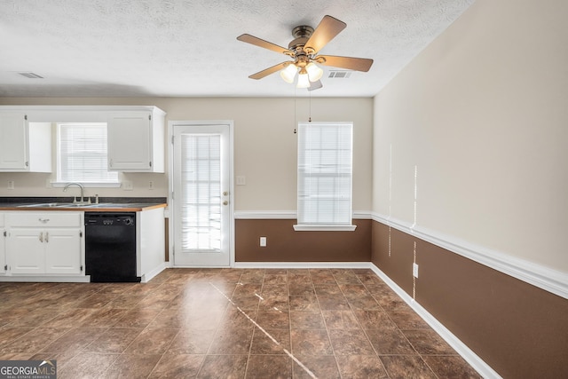 kitchen with white cabinetry, plenty of natural light, and black dishwasher