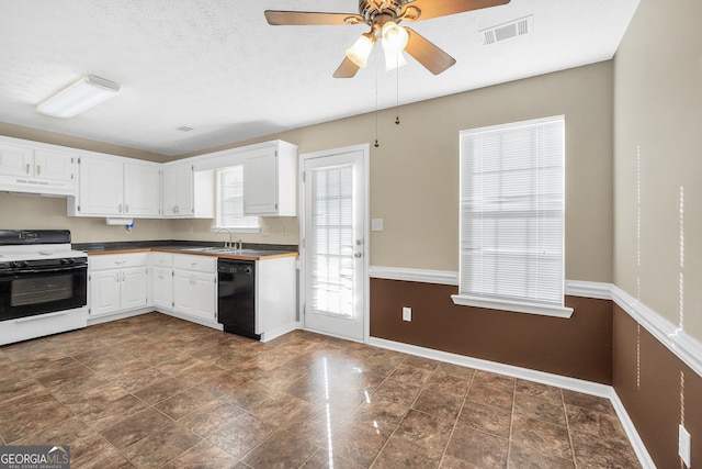 kitchen featuring black dishwasher, white gas range oven, and white cabinets