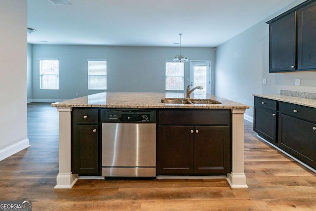 kitchen featuring dishwasher, sink, hanging light fixtures, a notable chandelier, and wood-type flooring