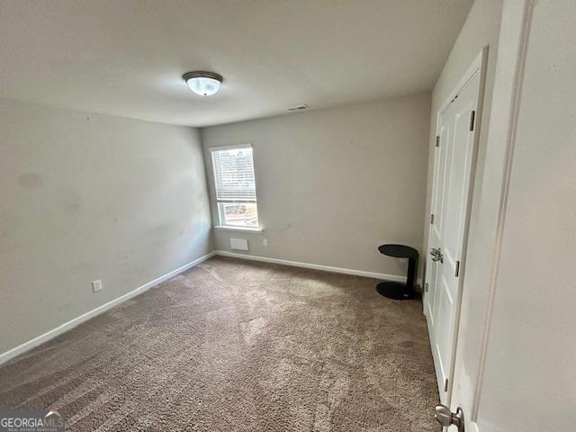 unfurnished bedroom featuring dark carpet