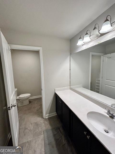 bathroom featuring vanity and toilet