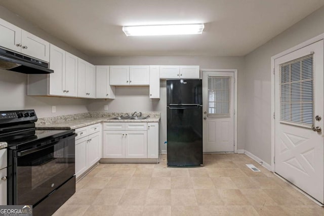 kitchen featuring black appliances, light stone counters, white cabinetry, and sink