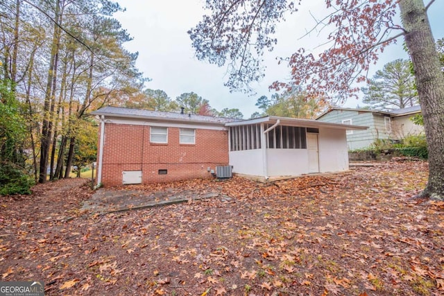 back of property featuring a sunroom and central air condition unit