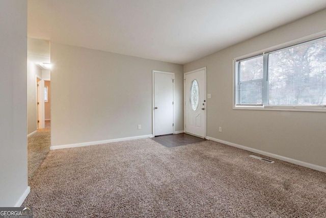 foyer featuring carpet flooring