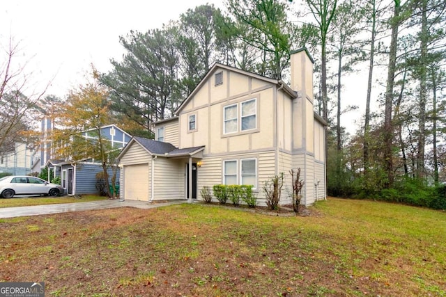 view of front of property with a garage and a front lawn