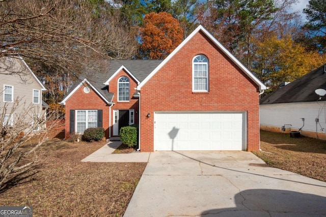 view of property featuring a garage and central AC