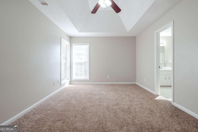 carpeted empty room with a textured ceiling and ceiling fan