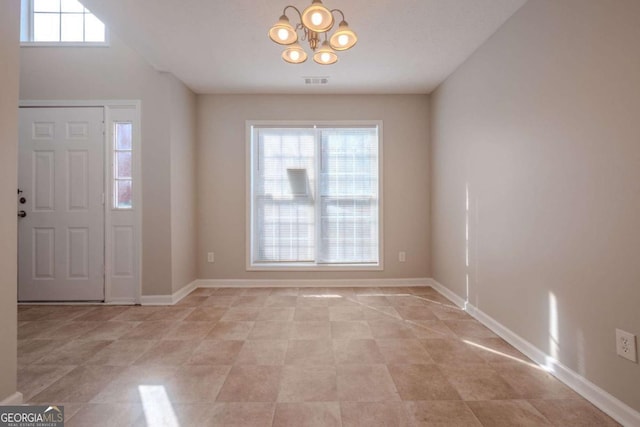 entryway featuring an inviting chandelier