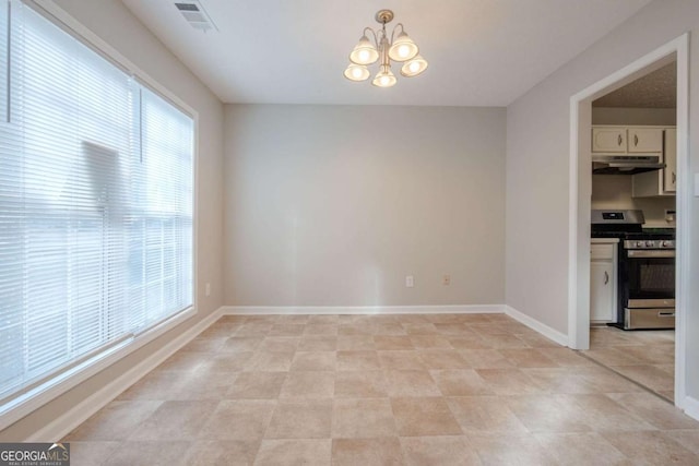 unfurnished dining area with a chandelier