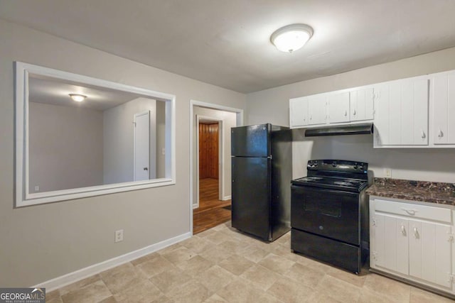 kitchen with dark stone counters, white cabinets, and black appliances