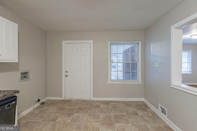 clothes washing area with cabinets, washer hookup, and plenty of natural light