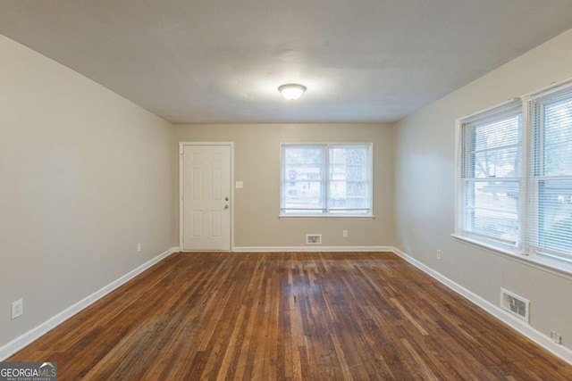 spare room featuring dark wood-type flooring