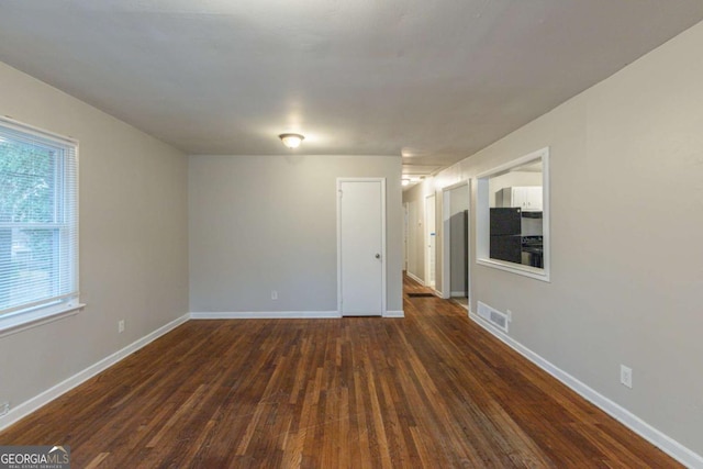 empty room with dark wood-type flooring