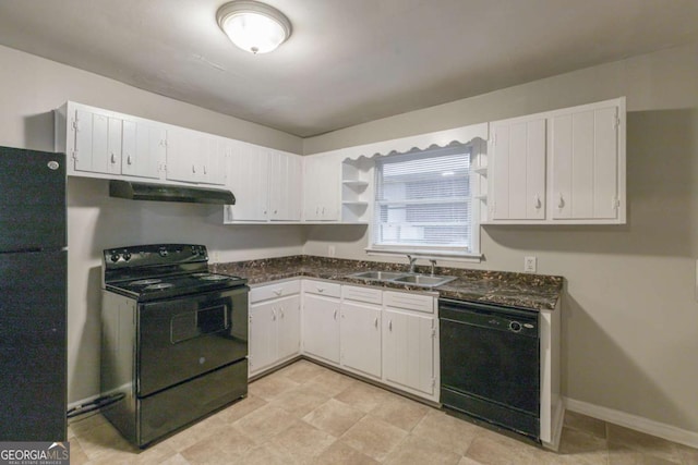 kitchen featuring dark stone countertops, sink, white cabinets, and black appliances