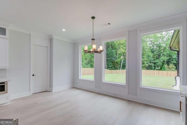 2626 Sardis Way, Buford, GA 30519 - unfurnished dining area with a chandelier, light wood finished floors, baseboards, and crown molding