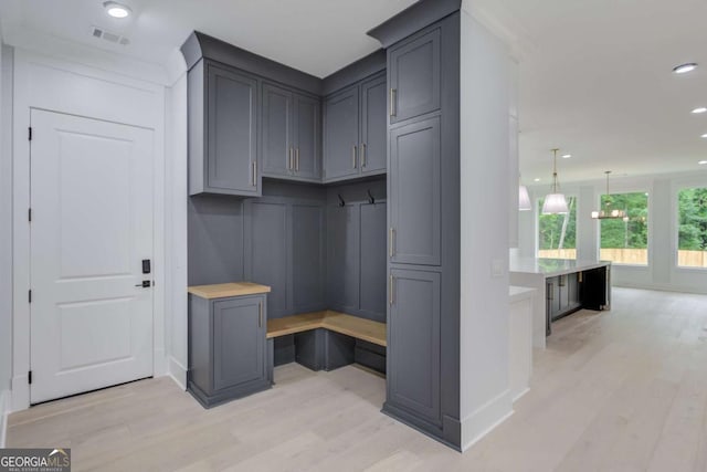 mudroom featuring light hardwood / wood-style floors and built in desk