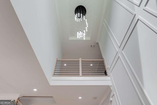 staircase featuring an inviting chandelier