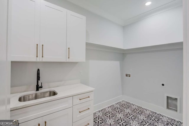 laundry area with hookup for an electric dryer, cabinets, sink, and washer hookup