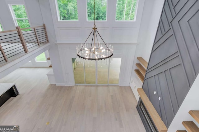 foyer entrance with a chandelier and light wood-type flooring