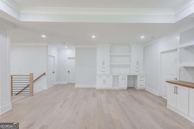 interior space with ornamental molding and light wood-type flooring