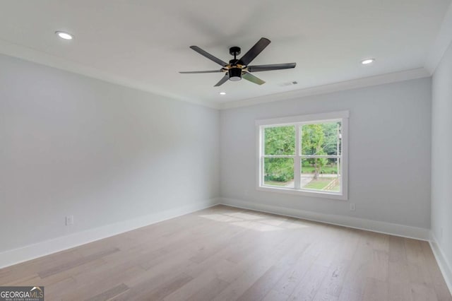 empty room with ceiling fan, light hardwood / wood-style floors, and ornamental molding