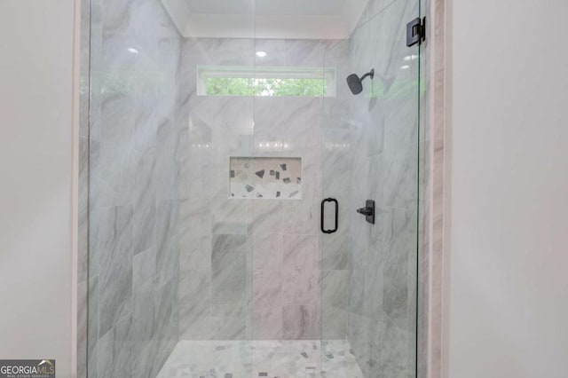 bathroom with a shower with door