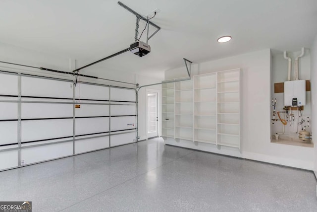 garage with a garage door opener and water heater