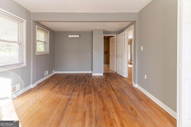 spare room featuring wood-type flooring