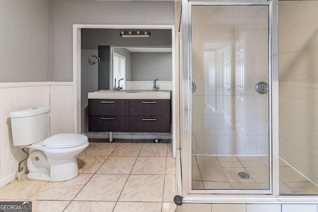 bathroom featuring walk in shower, tile patterned flooring, vanity, and toilet