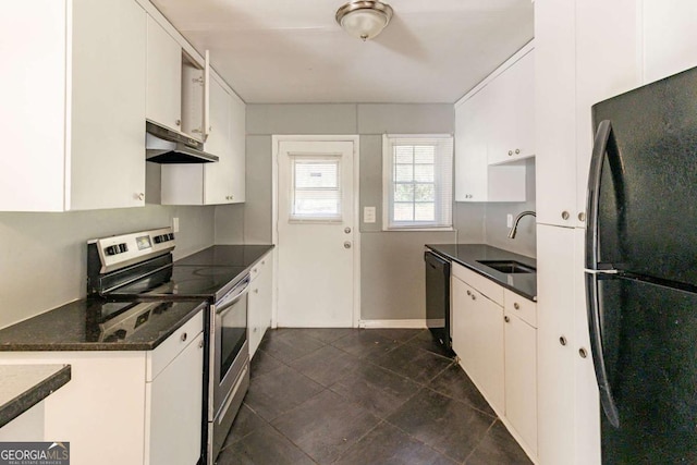 kitchen with white cabinetry, sink, dark stone countertops, black appliances, and dark tile patterned flooring