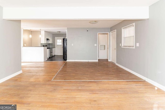 spare room with light hardwood / wood-style flooring