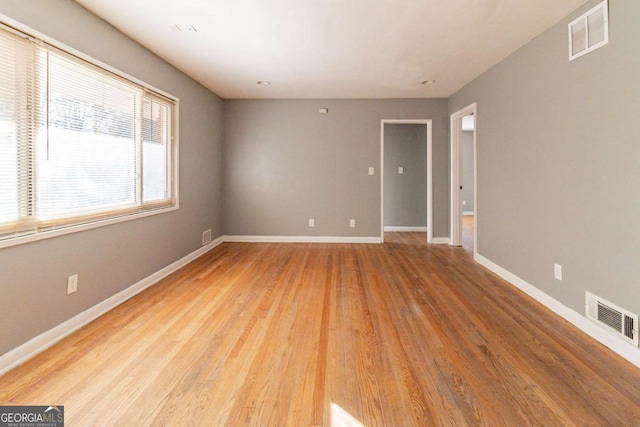 unfurnished room featuring light hardwood / wood-style floors