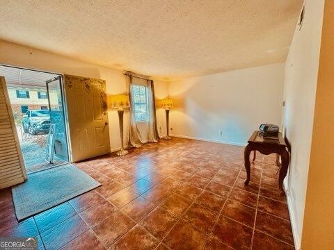 spare room with a textured ceiling