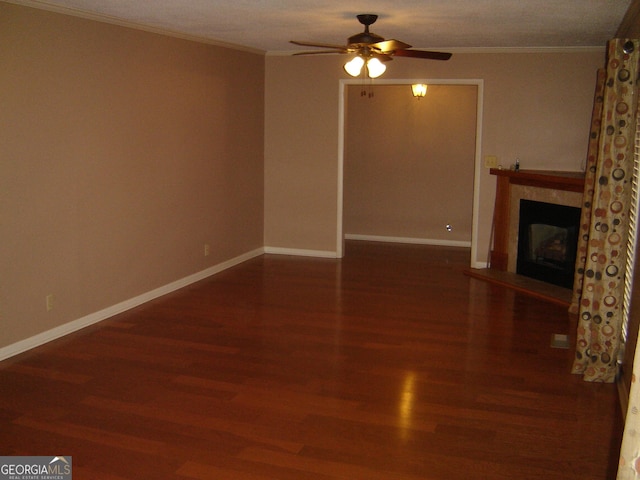 unfurnished living room with hardwood / wood-style floors, ceiling fan, and ornamental molding