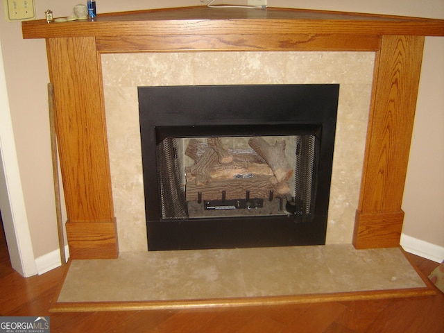 room details featuring a fireplace and hardwood / wood-style floors