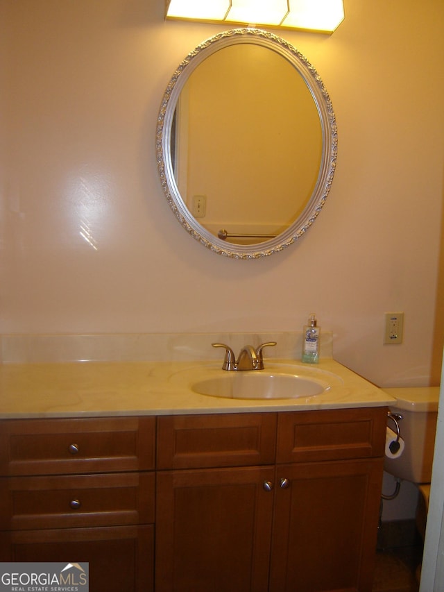 bathroom featuring vanity and toilet