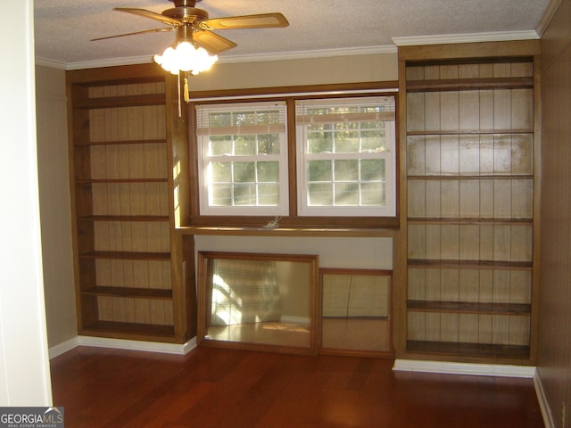 unfurnished living room with ornamental molding, a textured ceiling, ceiling fan, and dark wood-type flooring