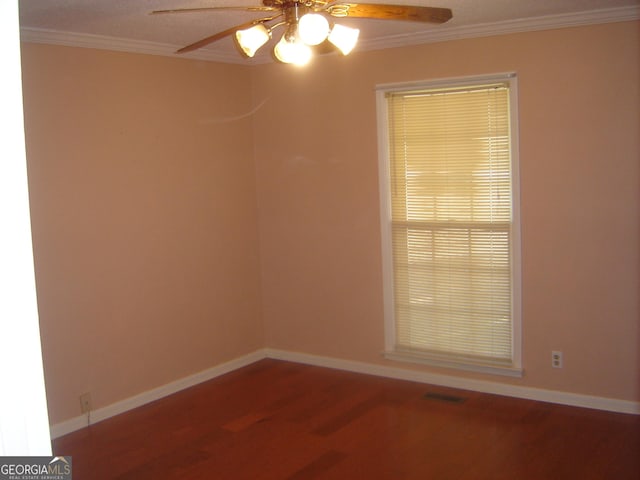 spare room featuring hardwood / wood-style floors, ceiling fan, and crown molding