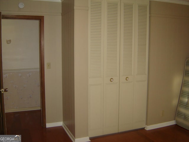 interior space featuring dark hardwood / wood-style flooring and ornamental molding