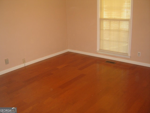 empty room featuring hardwood / wood-style flooring