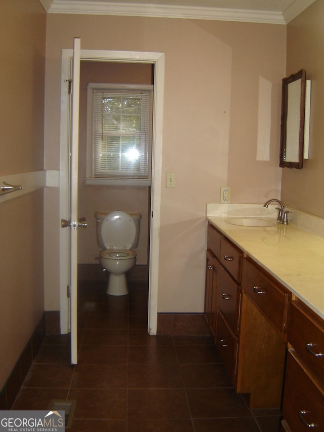 bathroom with tile patterned flooring, vanity, toilet, and ornamental molding